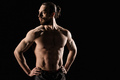 An athletic man on dark background - PhotoDune Item for Sale