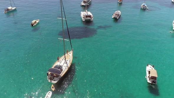 Aerial view circulating sailboat anchored in the mediterranean sea, Greece.