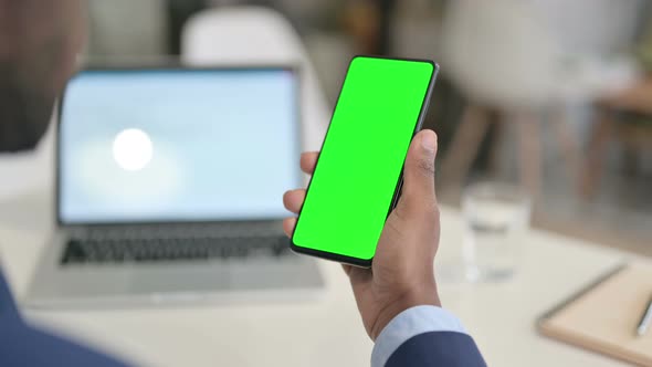 Businessman Holding Smartphone with Green Chroma Key Screen