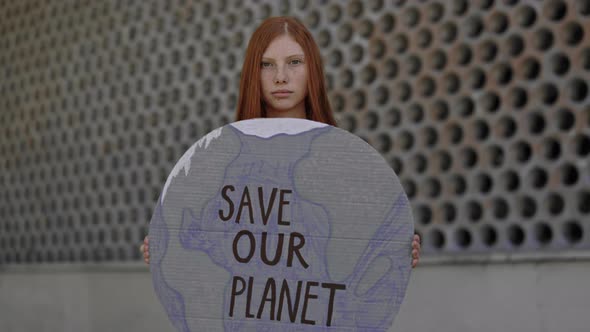 Young Woman Holding Cardboard with Save Our Planet Phrase