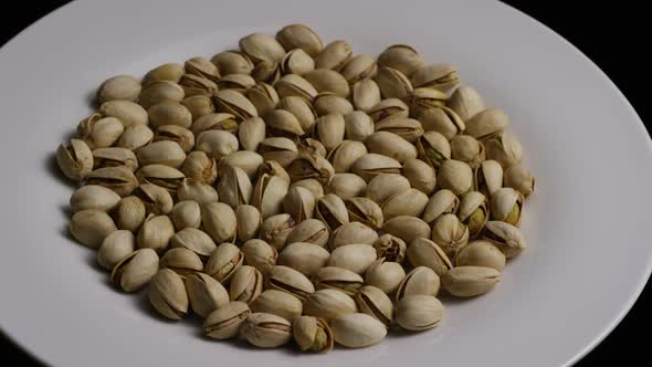 Cinematic, rotating shot of pistachios on a white surface - PISTACHIOS 011