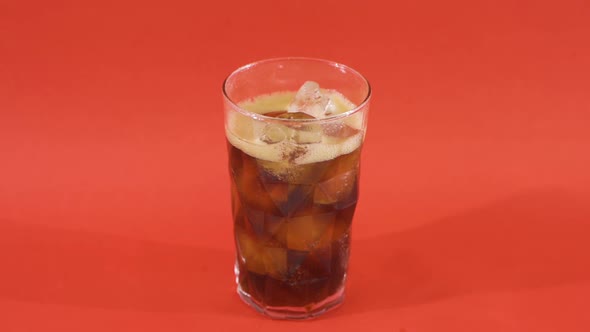 Coke glass full of ice cubes.