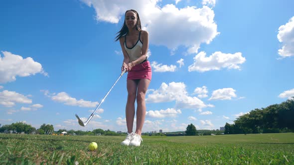 A Lady Is Striking a Golf Ball and Getting Happy After