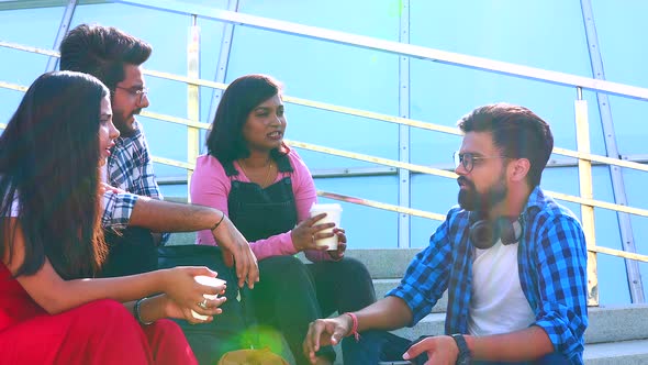 Indian Friends Sitting on Stairs Outdoors with Copybooks