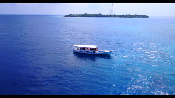 Aerial travel of marine coast beach lifestyle by blue green ocean with white sandy background of adv