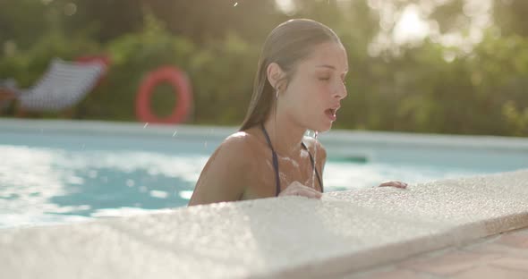 Woman Into Water Relaxing in Swimming Pool in Sunny Day