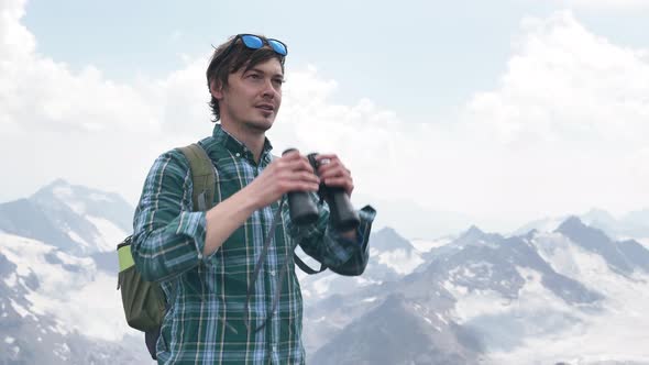 Young Man Rejoices Looking Through Binoculars and Goes Away