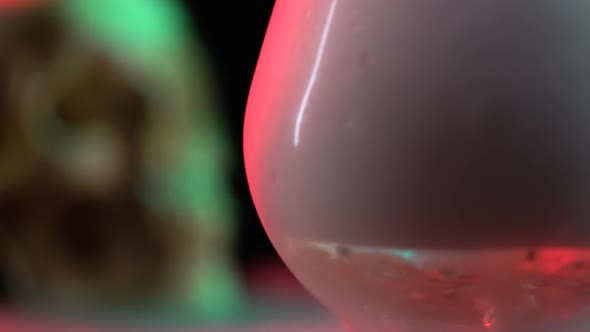 Closeup of Skull Near Blurred View Glass with Smoke and the Effect of Dry Ice on Black Background