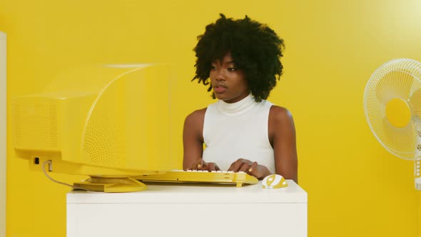 Beautiful Black Woman Is Working at Retro PC