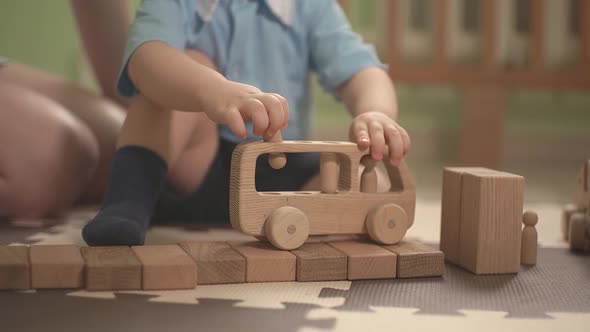 Child Playing with Wooden Toy