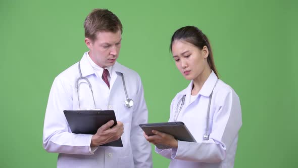 Multi-ethnic Couple Doctors Having Discussion Together
