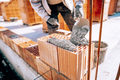 construction industry details - worker bricklayer building exterior walls with mortar and bricks - PhotoDune Item for Sale