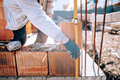 Bricklayer industrial worker installing brick masonry - PhotoDune Item for Sale