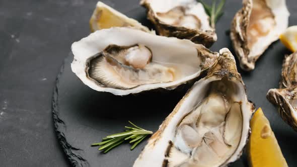 Oysters with Lemon on Black Plate