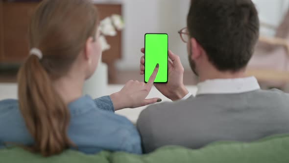 Rear View of Couple Using Smartphone with Green Chroma Key Screen