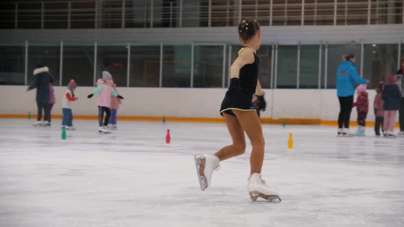 A Little Girl Figure Skater Ice Skating on the Public Rink