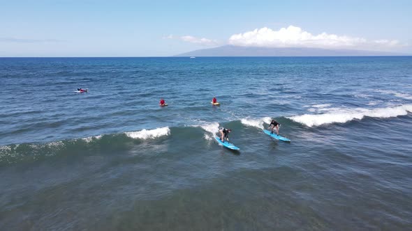 Aerial View of Surfers and Waves in Crystal Blue Ocean in Maui Hawaii