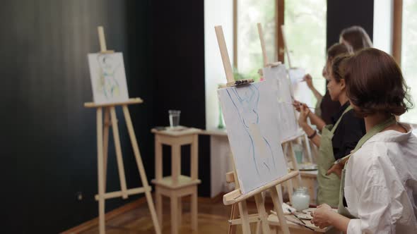 Lovely Women Painting Female Silhouette on Canvas at Workshop