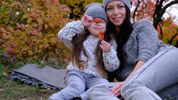 Baby with Young Mother in Autumn Park