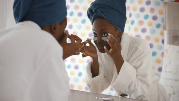 Afro-american Female Doing Skincare Procedure in Bathroom