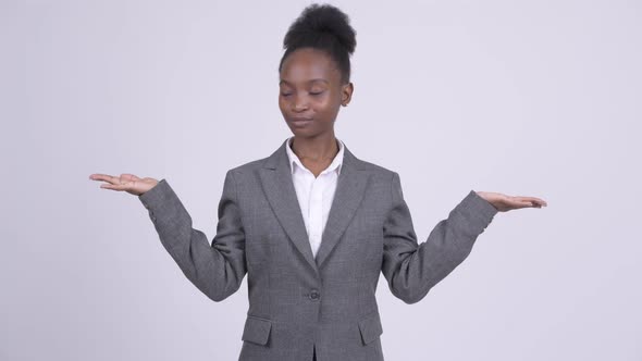 Young Happy African Businesswoman Comparing Something