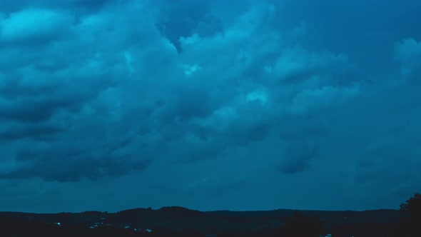 Timelapse of movement of dark blue night heavy clouds 4k footage alt