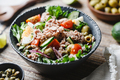 Canned tuna salad with fresh vegetables, capers and olives in a black bowl - PhotoDune Item for Sale