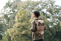 Young man walking with backpacks over natural park background. - PhotoDune Item for Sale