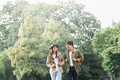 Couple walking with backpacks over natural background - PhotoDune Item for Sale
