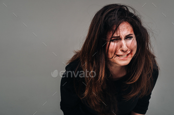 an isolated gray background. Violence against women.