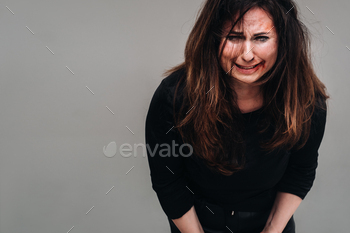 an isolated gray background. Violence against women.
