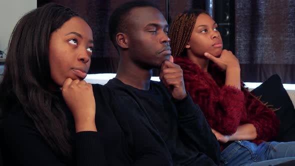 Three African Friends Together Think About Something in Living Room