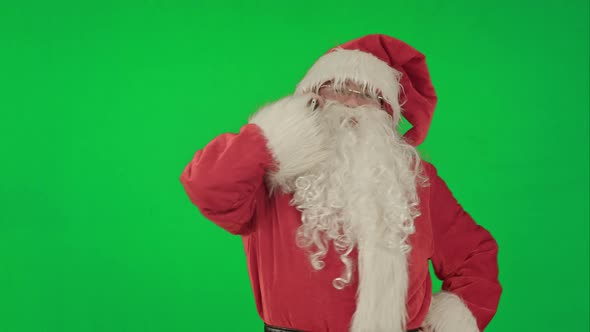 Santa Talking on His Cellphone with a Surprised Look on His Face. on a Green Screen Chrome Key