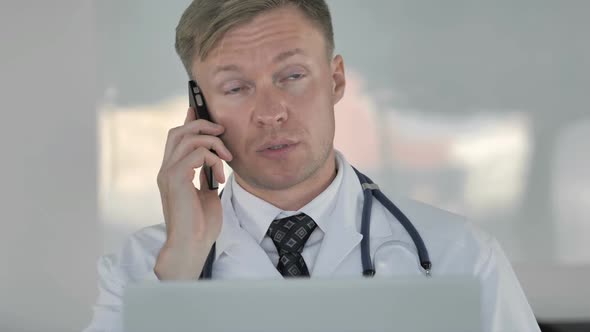Doctor Talking on Phone with Patient