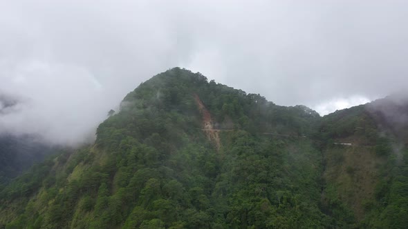 The Rainy Clouds Covered the Top of Green Forest Mountain. Rain Clouds in a Tropical Climate