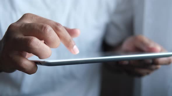 Man Hand Using Digital Tablet on Black Background