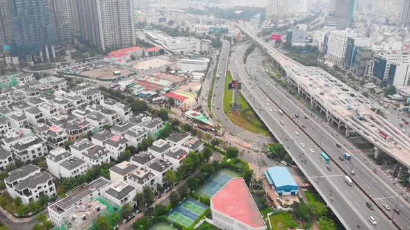 Shooting Aerial Unmanned Flight From Top View of the City Bridge with Cars and Motorbikes Against