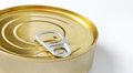 Close-up of a golden tin can with a built-in key. - PhotoDune Item for Sale