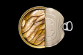 Open tin can of smoked sprats in oil, isolated on black background. Top view, flat lay. - PhotoDune Item for Sale