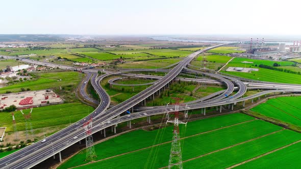 Freeway Road with Moving Cars Between Green Fields