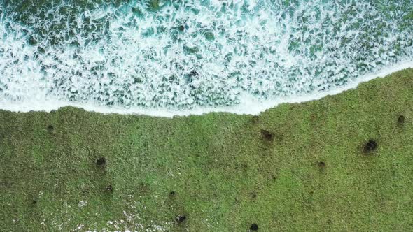 Aerial drone sky of idyllic island beach break by turquoise lagoon with white sand background of a d