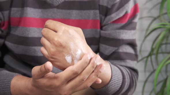 Man Applying Beauty Cream Onto Skin