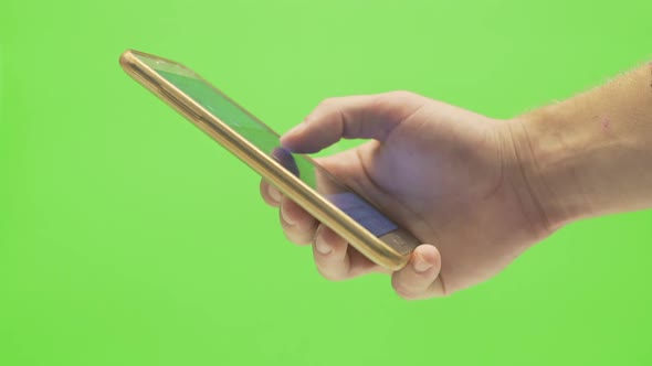 A single hand scrolling through a social media platform with a  smartphone on a green screen backgro