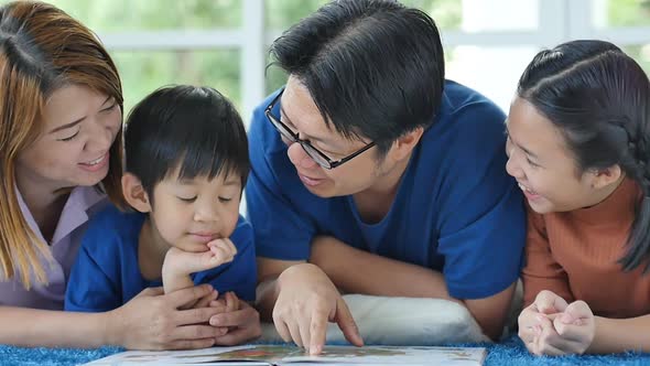 Happy Asian Family Reading Book At Home
