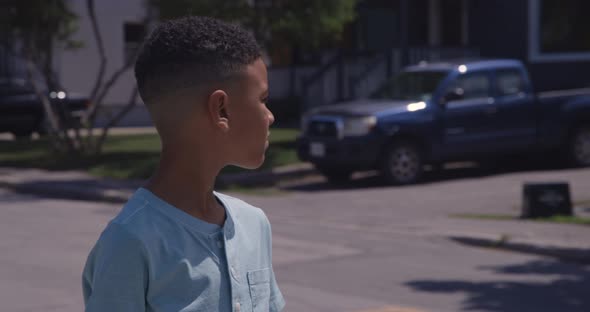 Young Black kid looking around in his neighbourhood