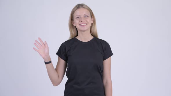 Young Happy Blonde Woman Smiling and Waving Hand