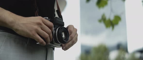 Man holding his analogue camera outside