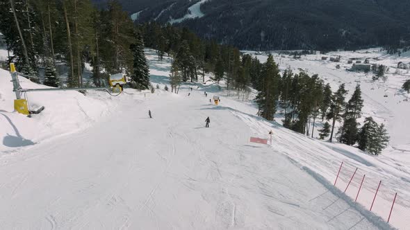 Aerial View of a Ski Resort with People Snowboarding and Skiing From a Hill