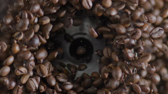 Fragrant Coffee Grains Grinding in Electric Grinder Top View Close Up