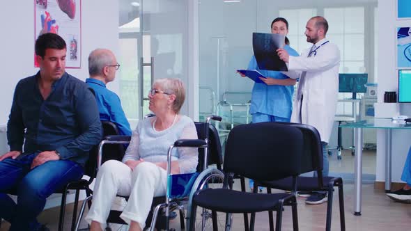 Nurse Looking at Radiography While Talking with Doctor